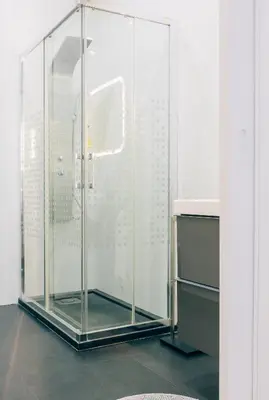 a glass shower stall in a white room at ORM Catedral & São Bento & Luiz Apartments in Porto