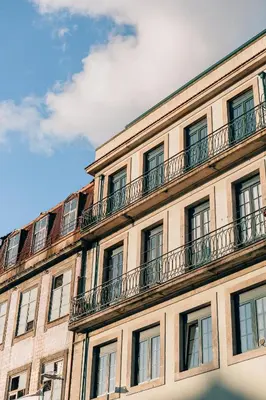 a building with balconies on the side of it at ORM Catedral & São Bento & Luiz Apartments in Porto