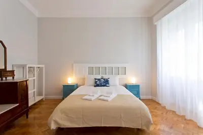 a bedroom with a bed with two towels on it at ORM Catedral & São Bento & Luiz Apartments in Porto