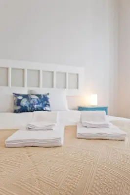 a large bedroom with two beds and a table at ORM Catedral & São Bento & Luiz Apartments in Porto