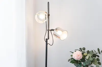 a floor lamp with a vase of pink roses at HiddenGem - Cherry on Top in Porto