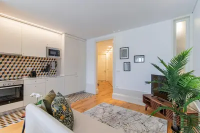 a living room with a couch and a tv at Rodrigues de Freitas 391 by LovelyStay in Porto