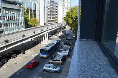 a view from a window of a city street with cars at Sense Porto in Porto