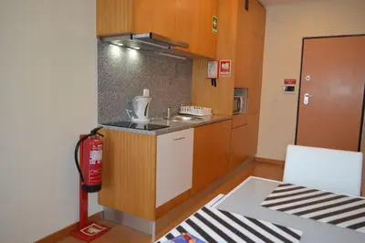 a small kitchen with a sink and a stove at Sense Porto in Porto