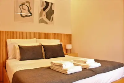 a bedroom with a bed with towels on it at Oporto Prime Studios in Porto