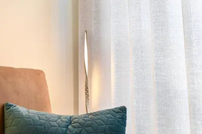 a chair sitting next to a window with a curtain at Lapa City Flat Porto - by Guest SPA in Porto