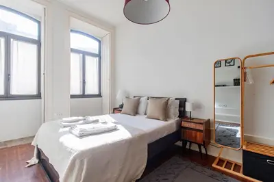 a bedroom with a large white bed with a mirror at Music Shell by LovelyStay in Porto