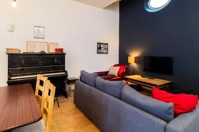 a living room with a couch and a piano at Music Shell by LovelyStay in Porto