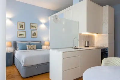 a small bedroom with a bed and a sink at CASA JOY Santa Catarina apartment in Porto