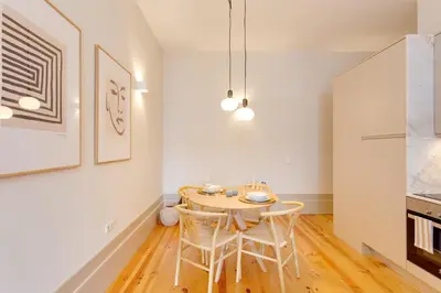 a small dining room with a table and chairs at Dom João Premium Apartment by DA'HOME in Porto