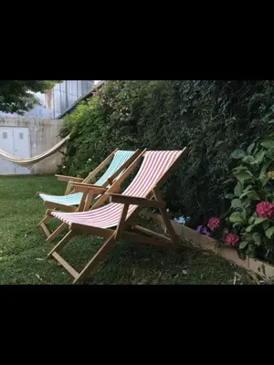 two deck chairs sitting on the grass in a yard at Casa do Teatro in Porto
