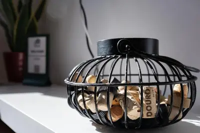 a bird cage filled with coins on a table at Porto Santa Maria Apartments in Porto