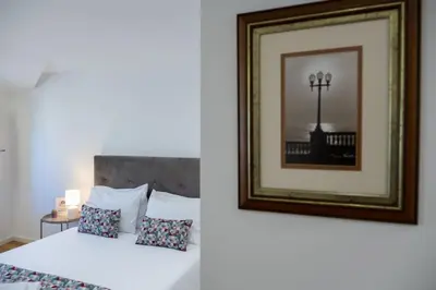 a bedroom with a bed and a picture of a street light at Porto Santa Maria Apartments in Porto