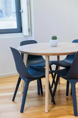 a table and chairs in a room at Porto Santa Maria Apartments in Porto