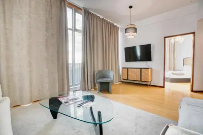 a living room with a glass table and a television at Apartment T1 - Porto in Porto