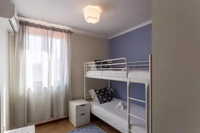 a small bedroom with a bunk bed and a window at Porto Residence Campanhã in Porto