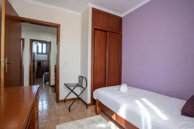 a bedroom with a bed and a desk and a chair at Porto Residence Campanhã in Porto