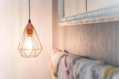 a pendant light hanging from a wall next to a couch at GuestReady - Bright home in the heart of Porto in Porto