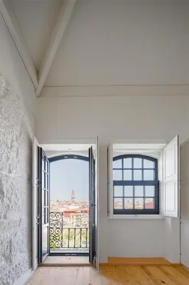 an empty room with a large window with a view at AgapeStay Porto in Porto