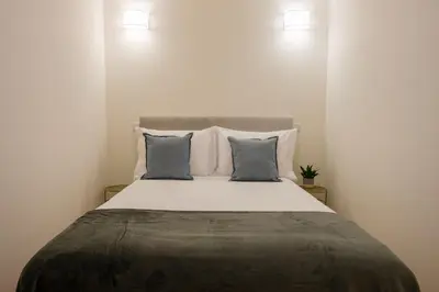 a bedroom with a large bed with two pillows at AgapeStay Porto in Porto