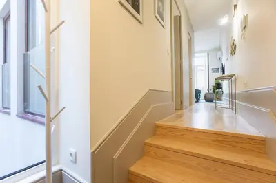 a staircase in a home with wooden floors at Alma do Porto - With AC in Porto