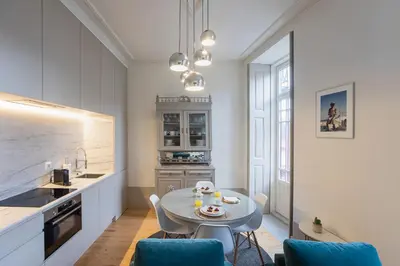 a kitchen and dining room with a table and chairs at Alma do Porto - With AC in Porto