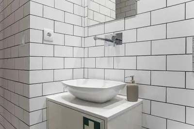 a white bathroom with a bowl sink on a counter at Alma do Porto - With AC in Porto