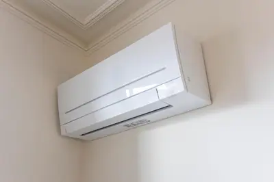 a white microwave hanging from a ceiling at Alma do Porto - With AC in Porto