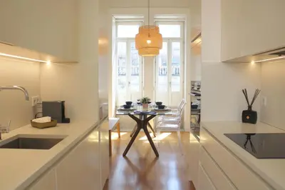 a kitchen with a table in the middle of it at Amazing Flores Duplex in Porto