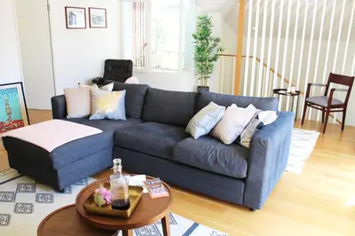 a living room with a blue couch and a table at Amazing Flores Duplex in Porto