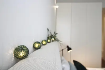 a line of christmas decorations on the back of a couch at Cativo Design Apartment in Porto