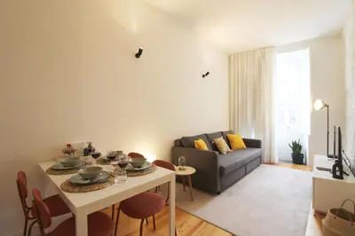 a living room with a table and a couch at Cativo Design Apartment in Porto
