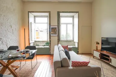 a living room with a couch and a table at Cativo Mezzanine Loft in Porto