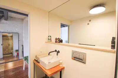 a bathroom with a sink and a mirror at Cativo Mezzanine Loft in Porto