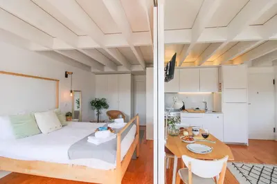 a bedroom and a living room with a bed and a table at Douro Dreams in Porto