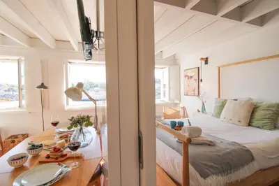 a bedroom with a bed and a table with food on it at Douro Dreams in Porto