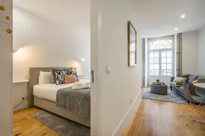 a bedroom with a bed and a living room at Almada Glamorous & Chic Oporto Downtown in Porto