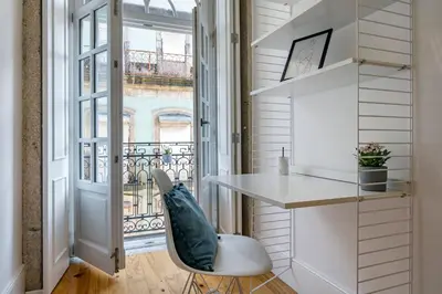 a small room with a desk and a balcony at Almada Glamorous & Chic Oporto Downtown in Porto