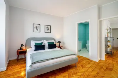 a bedroom with a bed with blue pillows at WHome FT169 Top Location 2-Bed Perfect to explore Porto in Porto