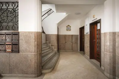 a hallway of a building with stairs and a door at Feel Porto Classic Apartment in Porto