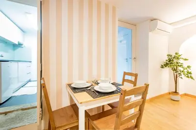 a kitchen and dining room with a table and chairs at Almada Hideaway w/ AC & Private Pool by LovelyStay in Porto