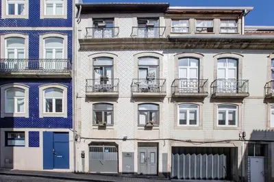 an apartment building with balconies on a city street at Almada Hideaway w/ AC & Private Pool by LovelyStay in Porto