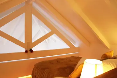 a room with a window and a bed and a lamp at Living Aliados Mezzanine Flat W/ AC in Porto
