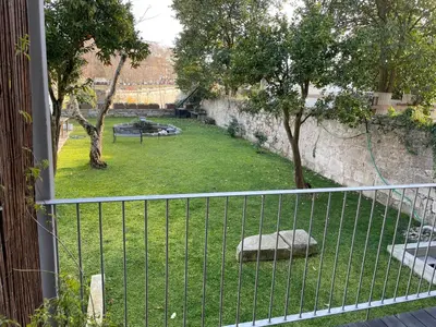 a fence in front of a yard with a park at LovePorto2 Balcony/Garden@Hist.C in Porto