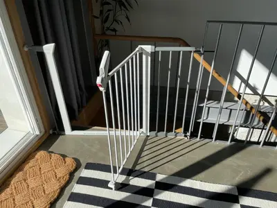 a stair railing in front of a door with a rug at LovePorto2 Balcony/Garden@Hist.C in Porto