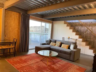 a living room with a couch and a table at LovePorto2 Balcony/Garden@Hist.C in Porto