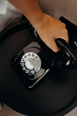 a person is holding a black cell phone at The Editory Garden Porto Hotel in Porto