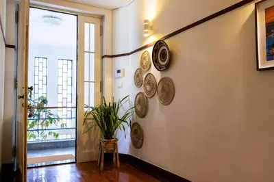 a hallway with plates on the wall with a plant at Fradelos Porto Centro in Porto