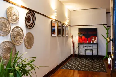 a hallway with hats on the wall and a fireplace at Fradelos Porto Centro in Porto