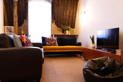 a living room with couches and a flat screen tv at Fradelos Porto Centro in Porto